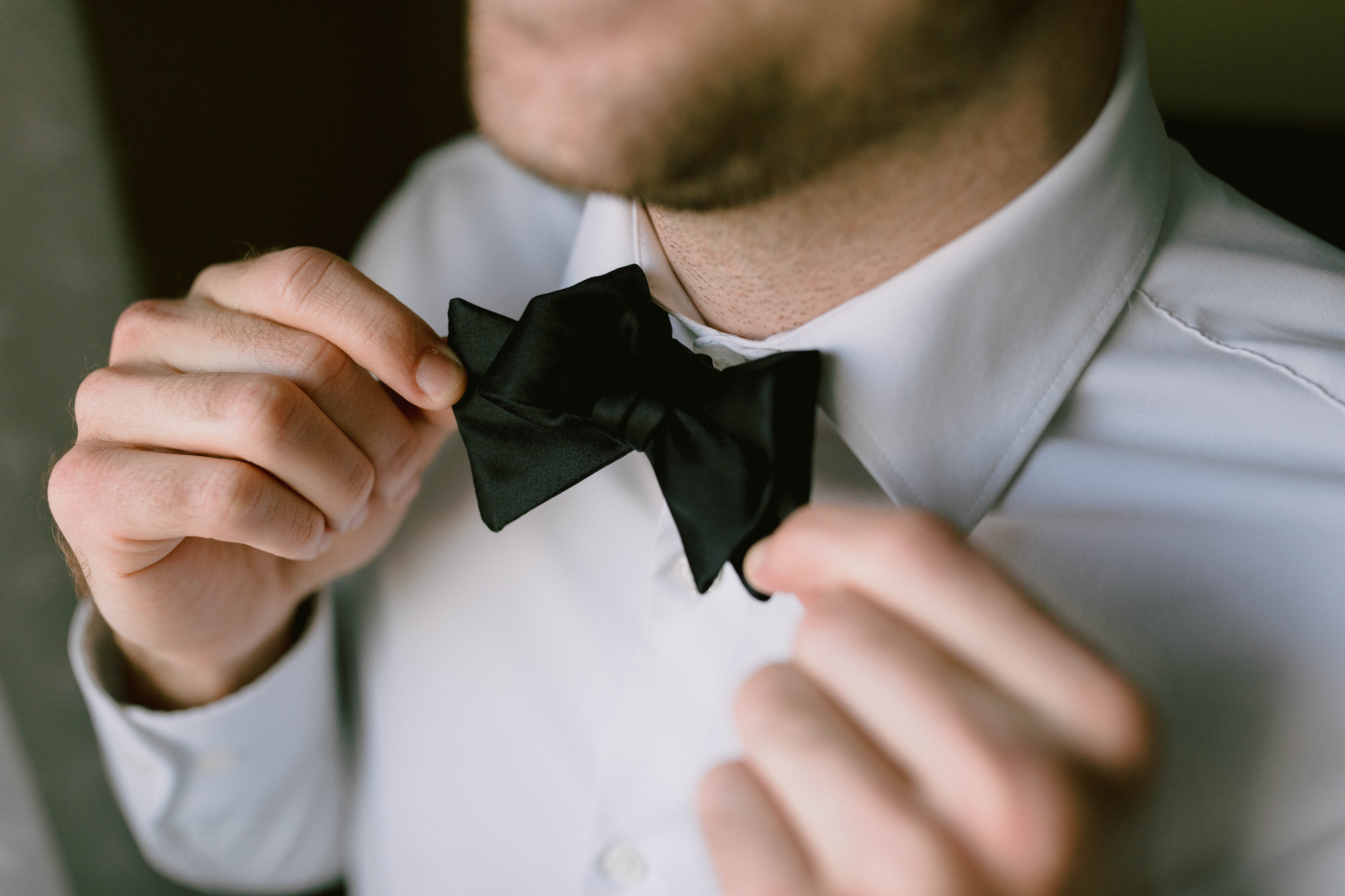 groom wearing a bold bowtie and getting ready for his wedding