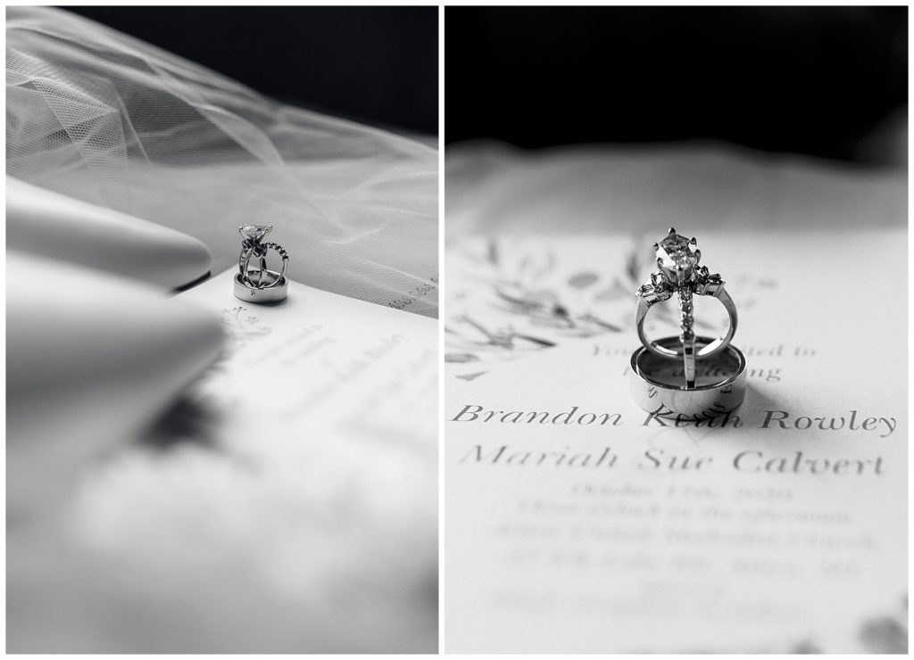 Wedding rings balancing on wedding invitation for a bridal detail photo. Photo has a luxury, timeless, and elegant look to it.