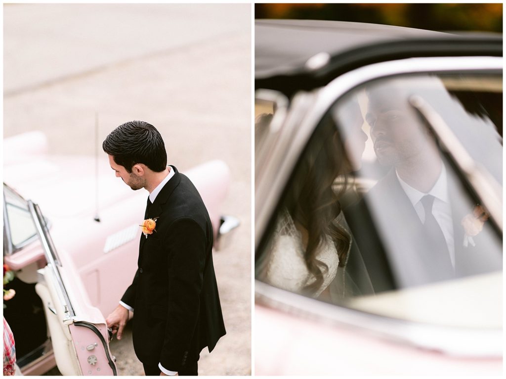 The groom opens the door for the bride getting into the classic car on their wedding day. Driving off in old car to their reception in detroit michigan.