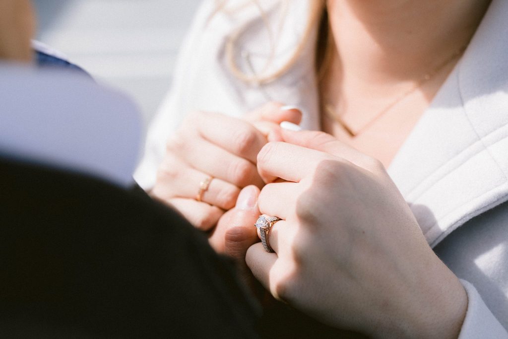 engagement session holds hands with engagement ring