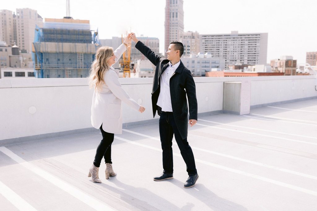 couple dances rooftop detroit engagement session